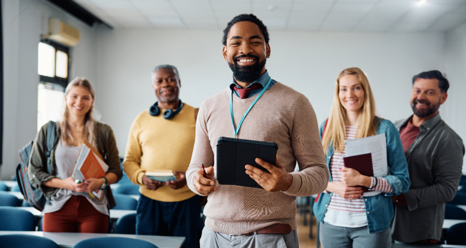Five colleagues standing in a classroom