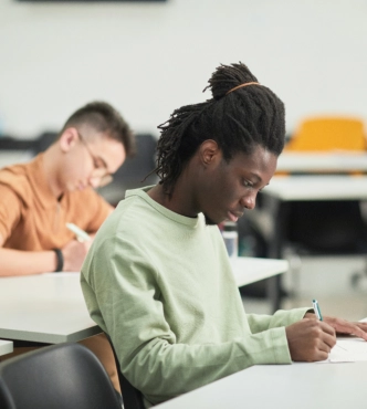 Student writing during classroom exam
